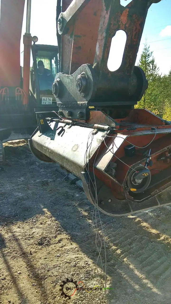 Excavator with vibration sensors and cables attached to bucket assembly for rotor balancing diagnostics using Vibromera equipment.